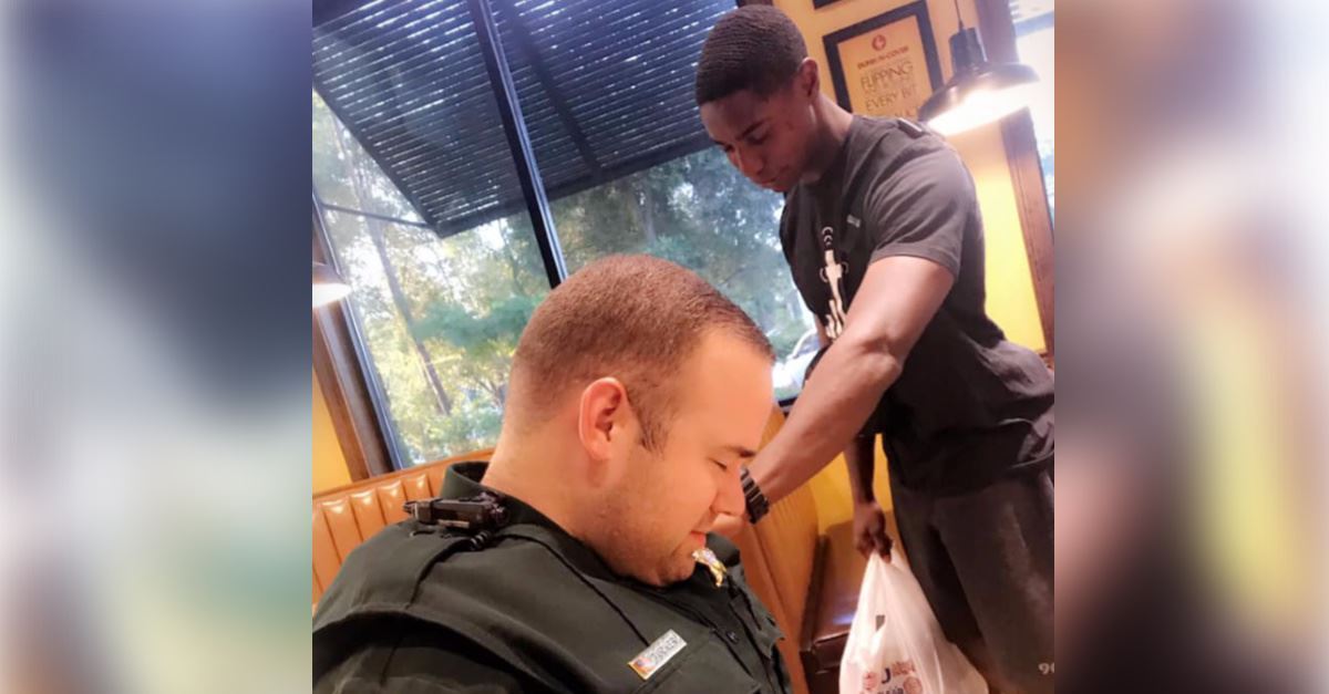 Photo of Young Man Praying Over Police Deputy Goes Viral