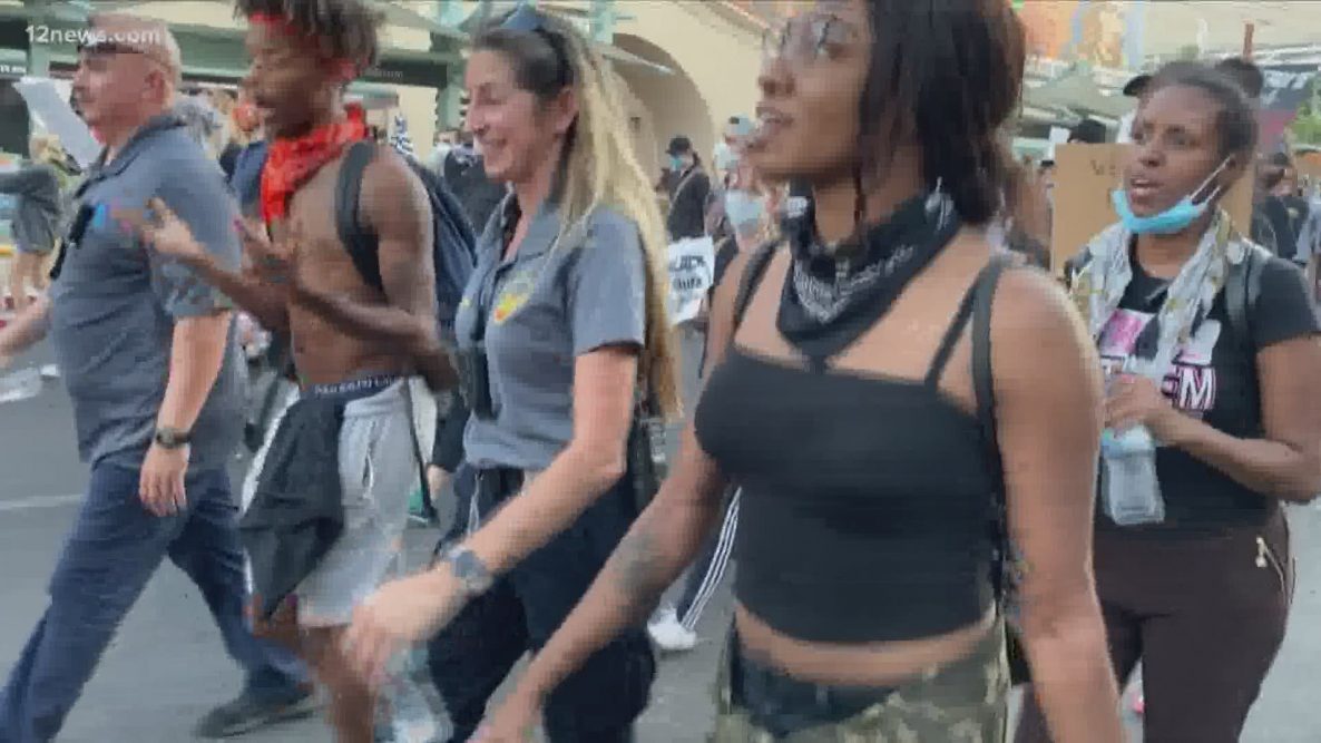 'We hear you': Phoenix Police march and take a knee in solidarity with protesters