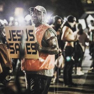 ‘[Expletive] Your Jesus’: Black Man Holding ‘Jesus Saves’ Sign Outside RNC Pelted By Protesters Seeking Social Justice